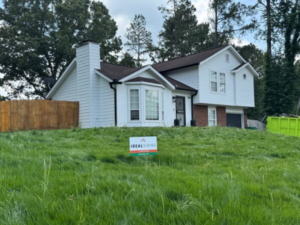 WOOD PANEL AND T1-11 SIDING REPLACED WITH JAMES HARDIE C+ ARCTIC WHITE PANELS AND 8.25