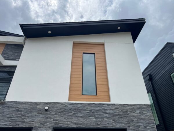 Replaced wood siding with Sagiper SagiWall v groove siding in Caramel Zebra color and front entrance ceiling with SagiRev soffit in same color