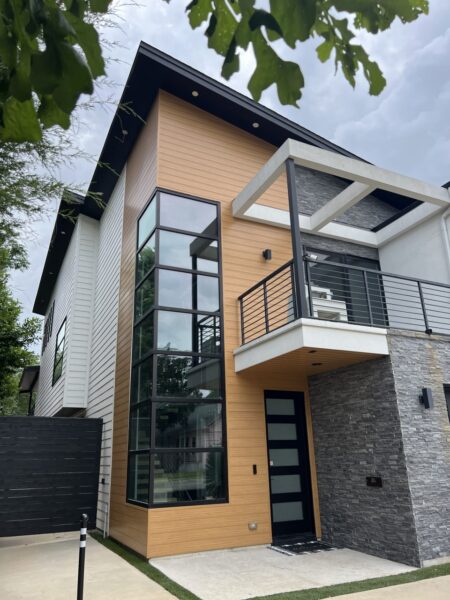 Replaced wood siding with Sagiper SagiWall v groove siding in Caramel Zebra color and front entrance ceiling with SagiRev soffit in same color