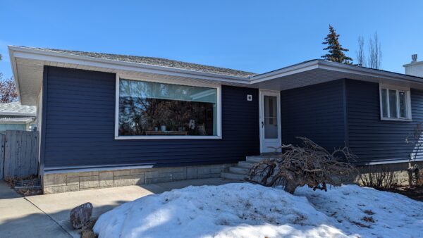 Remove vinyl siding and install new royal Navy Blue siding on sunroom of home