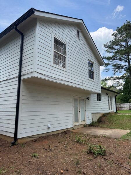 WOOD PANEL AND T1-11 SIDING REPLACED WITH JAMES HARDIE C+ ARCTIC WHITE PANELS AND 8.25