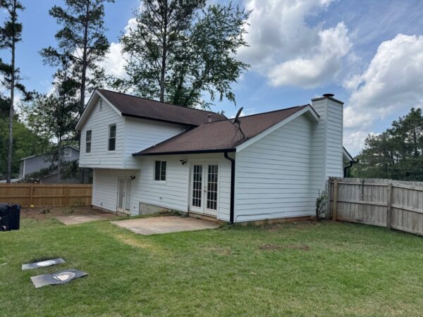 WOOD PANEL AND T1-11 SIDING REPLACED WITH JAMES HARDIE C+ ARCTIC WHITE PANELS AND 8.25