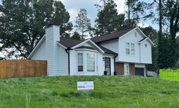 WOOD PANEL AND T1-11 SIDING REPLACED WITH JAMES HARDIE C+ ARCTIC WHITE PANELS AND 8.25