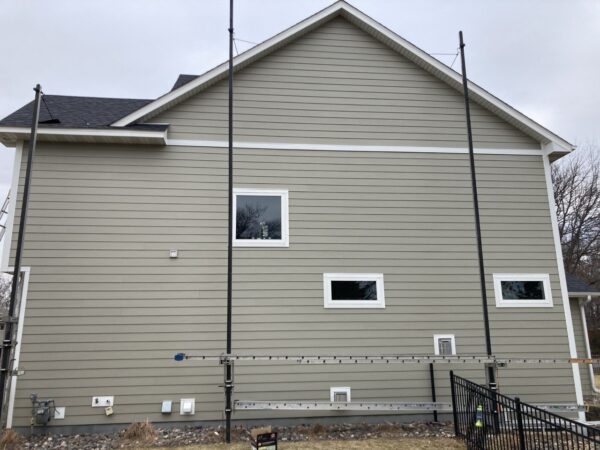 Resided 20 year old failing fiber cement wall (1,200 square feet) with James Hardie Plank siding (with 7” reveal) Cedarmill in Monterey Taupe color.
