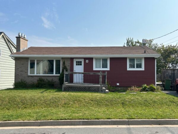 Home exterior renovation with new vinyl red siding