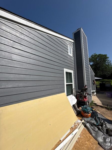 Installed James Hardie Cedarmill lap siding with matching primed trims and corners on designated exterior areas.