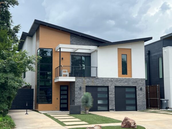 Replaced wood siding with Sagiper SagiWall v groove siding in Caramel Zebra color and front entrance ceiling with SagiRev soffit in same color.